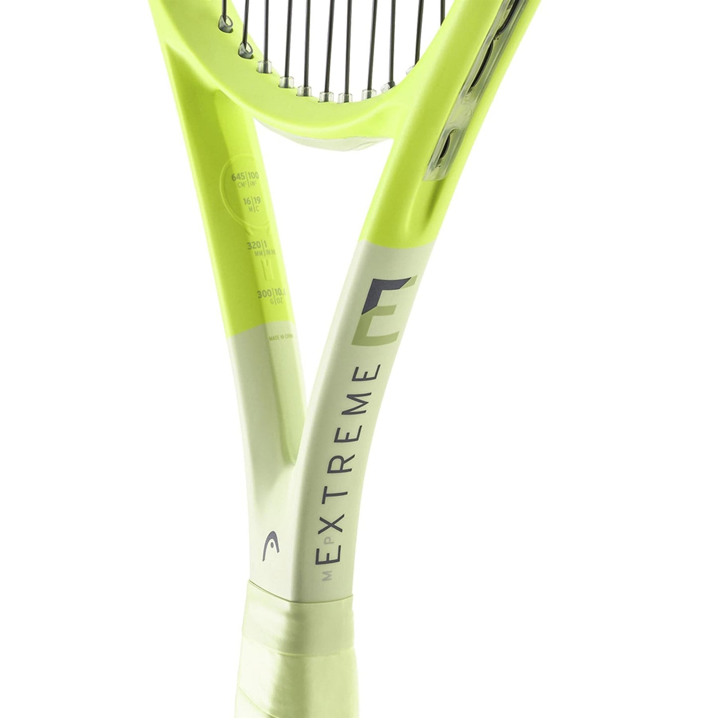 Close-up of a green HEAD Extreme MP 2024 Tennis Racket, highlighting the grip and part of the strings. The word "EXTREME" is printed on the neck and incorporates HEAD Auxetic 2.0 technology for exceptional spin.