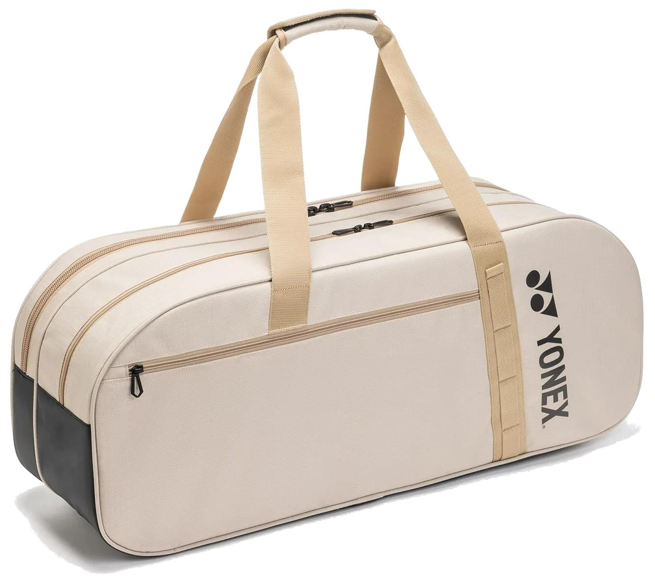 The Yonex BA72631WEX Gearlogic Tournament Tennis Bag in beige features tan straps, a front zip pocket, dual zippered main compartments, a padded handle, and a black Yonex logo on the side.