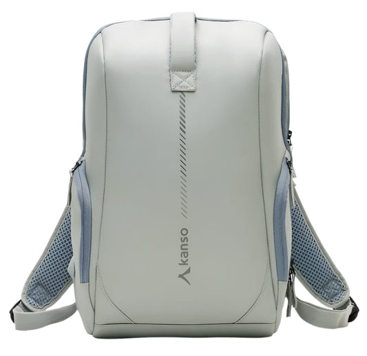 The Kanso Intuko Tennis 23L Backpack in gray is a sleek, minimalist accessory featuring blue mesh side pockets, padded shoulder straps, and a discreet racket compartment. It has reflective print, a vertical design element, and the brand name "Kanso," embodying modern style.