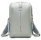 The Kanso Intuko Tennis 23L Backpack in gray is a sleek, minimalist accessory featuring blue mesh side pockets, padded shoulder straps, and a discreet racket compartment. It has reflective print, a vertical design element, and the brand name "Kanso," embodying modern style.