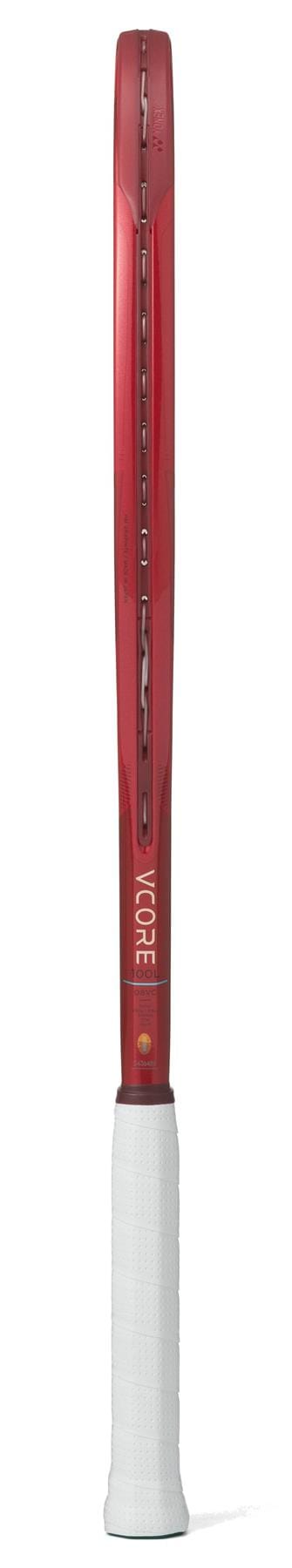 The Yonex VCORE 100L Ruby Red 2026 tennis racket is shown from the side, highlighting its thin frame, impressive spin potential, and white grip handle.