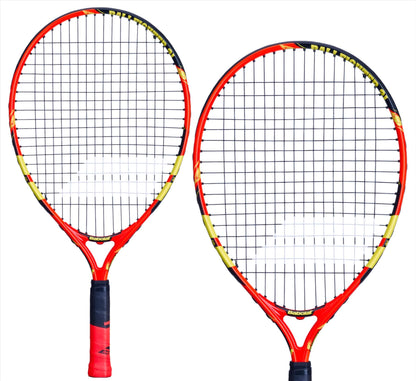 Two Babolat Ballfighter 21 Tennis Rackets in vibrant hues of orange, black, and yellow are arranged against a white background. One racket is slightly tilted, while the other stands upright, making them ideal for teaching young players effective grip techniques in tennis.