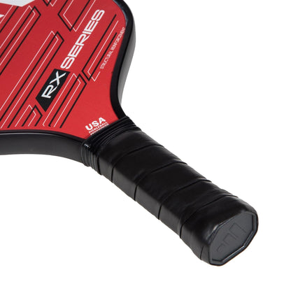 Close-up of the adidas RX ATTK 3.3 Pickleball Paddle handle with black grip tape. Its red face features geometric patterns, "RX Series" text, and a small "USA" marking—ideal for intermediate players.