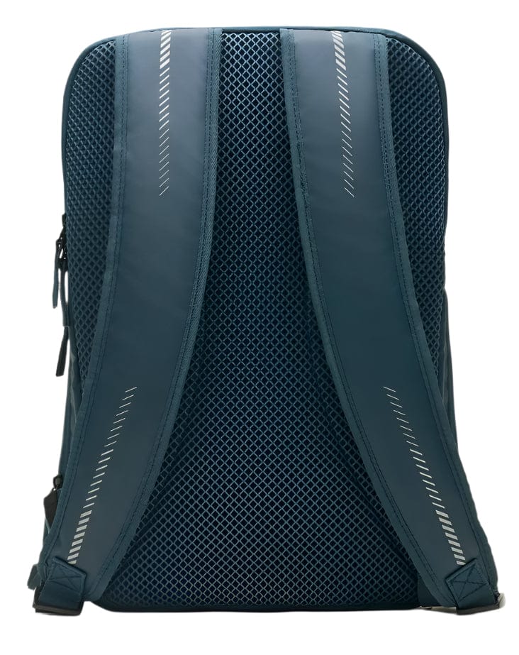 The image shows the back of a navy Kanso Intuko Tennis 23L Backpack with mesh-lined shoulder straps and reflective details. Its durable material and minimalist design make it an ideal everyday companion.