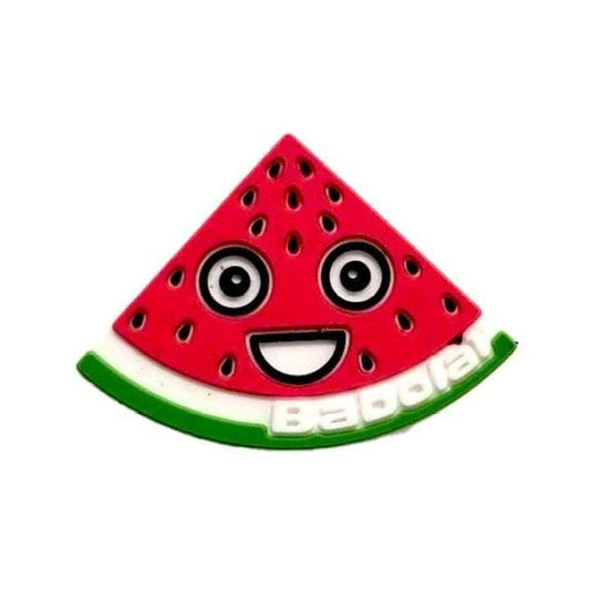 The Babolat Loony Damp Tennis Dampener - Watermelon features a cartoon watermelon slice with a smiling face, big eyes, seeds, and a green-and-white rind—adding playful style and fun to your racket from the trusted brand Babolat.