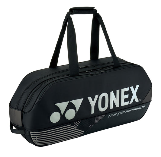 The Yonex 92431WEX Pro Tournament 6 Racket Tennis Bag in black features a sleek and streamlined design with two carry handles and a prominent logo. Engineered for professional performance, it includes multiple compartments ideal for organizing your rackets.