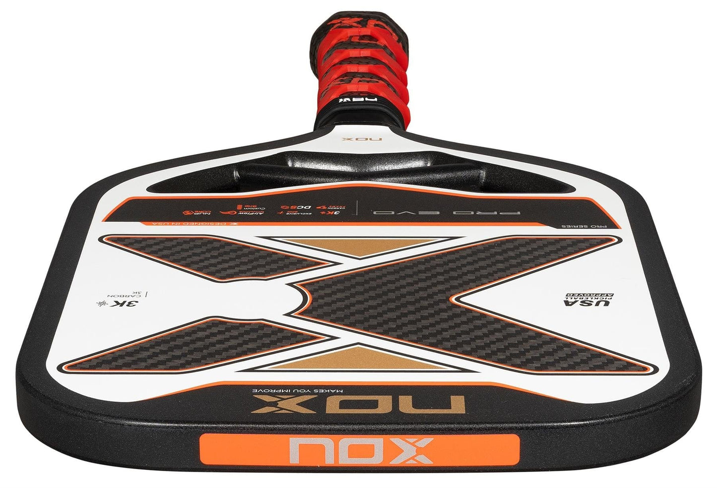A close-up of the NOX Pro Evo Pickleball Paddle by NOX, showing its black, white, and orange design with carbon fiber details. Enhanced spin and control, plus "Pro Evo" and "USA Pickleball Approved" are visible on the paddle.