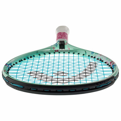 A mint and black HEAD Coco 21 Junior Tennis Racket, inspired by Coco Gauff's style, is seen from the top angle, highlighting its strings and handle. The frame boasts a light blue design with subtle pink accents and includes a Damp+ insert.