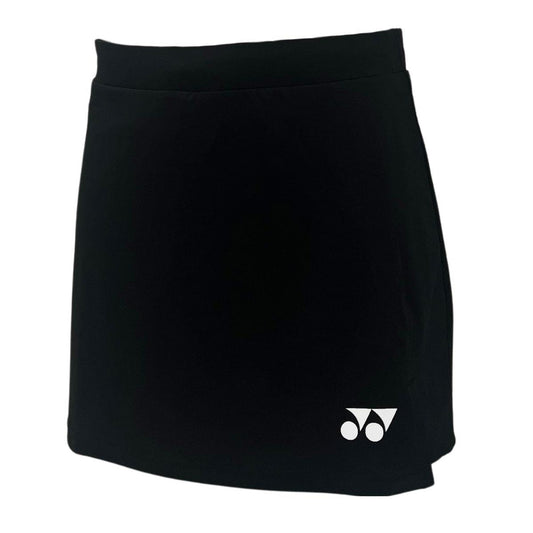 The Yonex YSKT2024 Women's Tennis Skirt/Skort in black, made from lightweight breathable materials, features the brand's iconic small white logo with circular and triangular shapes on the lower left side.