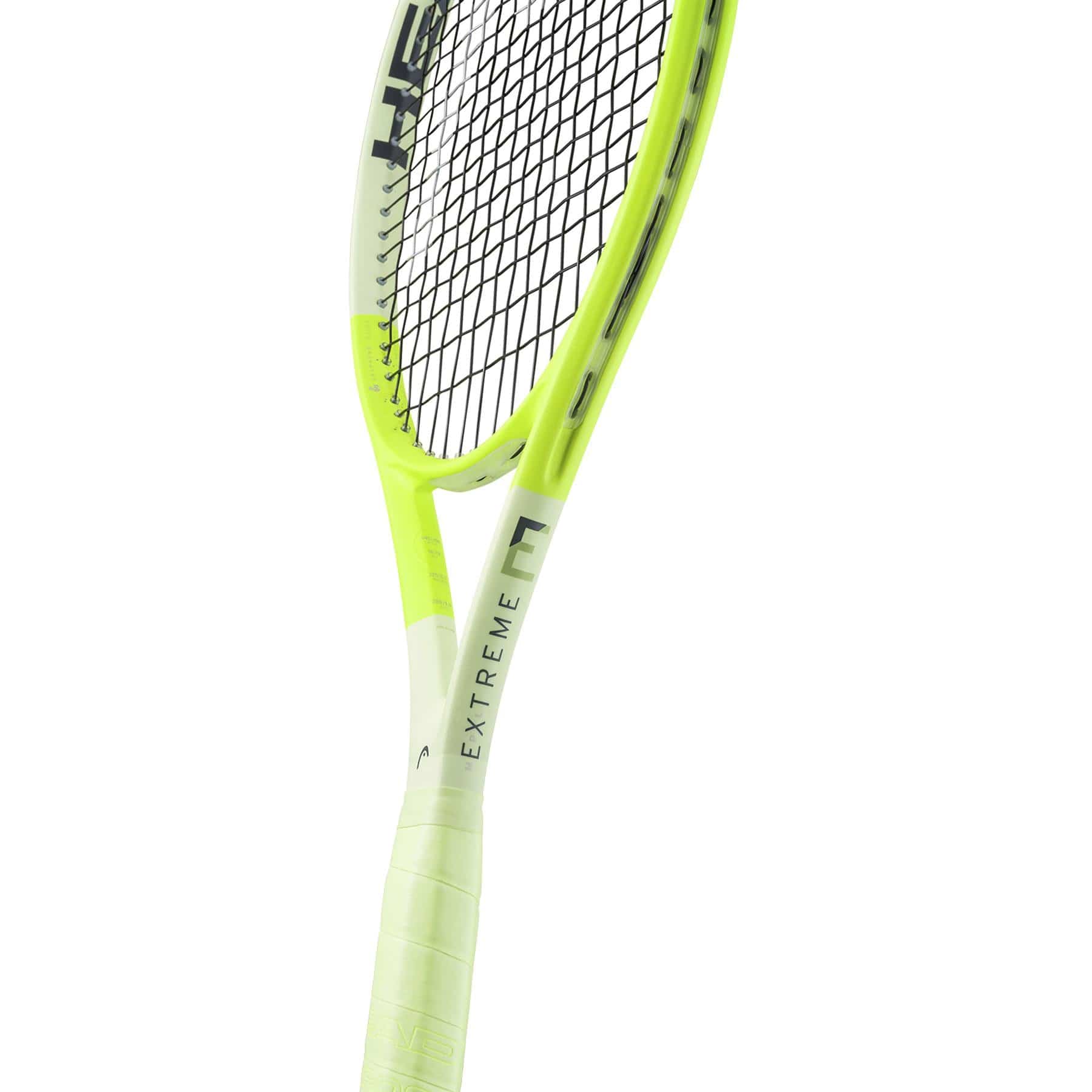 A close-up of the HEAD Extreme MP L 2024 Tennis Racket by HEAD, a yellow and black lightweight racket with "EXTREME" on the white frame near the handle, celebrated for its impressive spin potential.