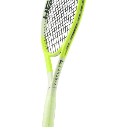 A close-up of the HEAD Extreme MP L 2024 Tennis Racket by HEAD, a yellow and black lightweight racket with "EXTREME" on the white frame near the handle, celebrated for its impressive spin potential.