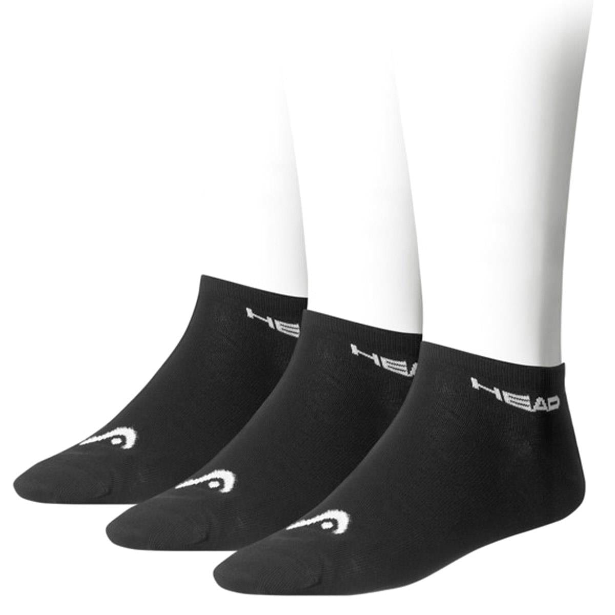 A trio of black HEAD Sneaker Tennis Socks is showcased on white mannequin feet. The soft cotton blend, low-cut design features "HEAD" in white near the cuff and a subtle toe design, with the branding distinctly visible from the side.