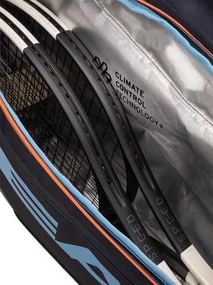 Close-up of the HEAD Pro 9 Racket Tennis Bag L - Navy by HEAD, as used by Jannik Sinner, featuring orange and blue trim, a silver CLIMATE CONTROL TECHNOLOGY+ lining, and room for multiple SPEED rackets.