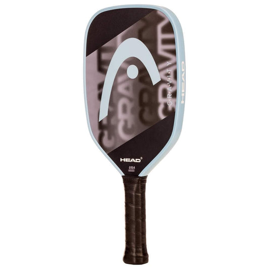 The HEAD Gravity Team EX 2025 Pickleball Paddle features a black face, light blue edge, large HEAD logo, and "GRAVITY" partially visible. It offers excellent control and has a handle wrapped in black grip tape.