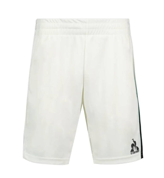 Le Coq Sportif Pro Mens Tennis Shorts in Marshmallow feature breathable fabric, an elastic waistband, subtle side stripes, and a black logo on the lower left leg. Ideal for tennis players, shown on a white background.