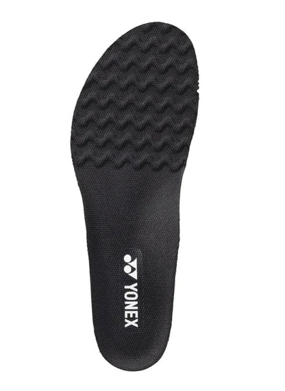 The Yonex AC196 Power Cushion Agility Insole in black boasts a textured surface with a wavy pattern for enhanced grip and features the brand's white logo. It is equipped with Power Cushion technology to boost your performance on the court.