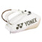 The Yonex 92426EX 6 Racket Pro Tennis Bag in sand beige boasts a sleek, curved design with two shoulder straps and proudly displays a large Yonex logo on the side. It offers multiple compartments for convenient storage.