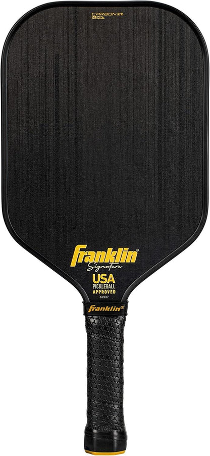 The Franklin Carbon STK 14.5mm Pickleball Paddle features a textured black handle, yellow "Franklin" branding, and "USA Pickleball Approved" on the face. This USAPA-approved paddle is built for reliable court performance.