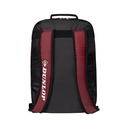 The Dunlop CX Club Tennis Backpack in black and red boasts padded shoulder straps with "Dunlop" printed on the left side. Its sleek design also includes a top handle, ideal for effortlessly carrying your tennis or badminton essentials.
