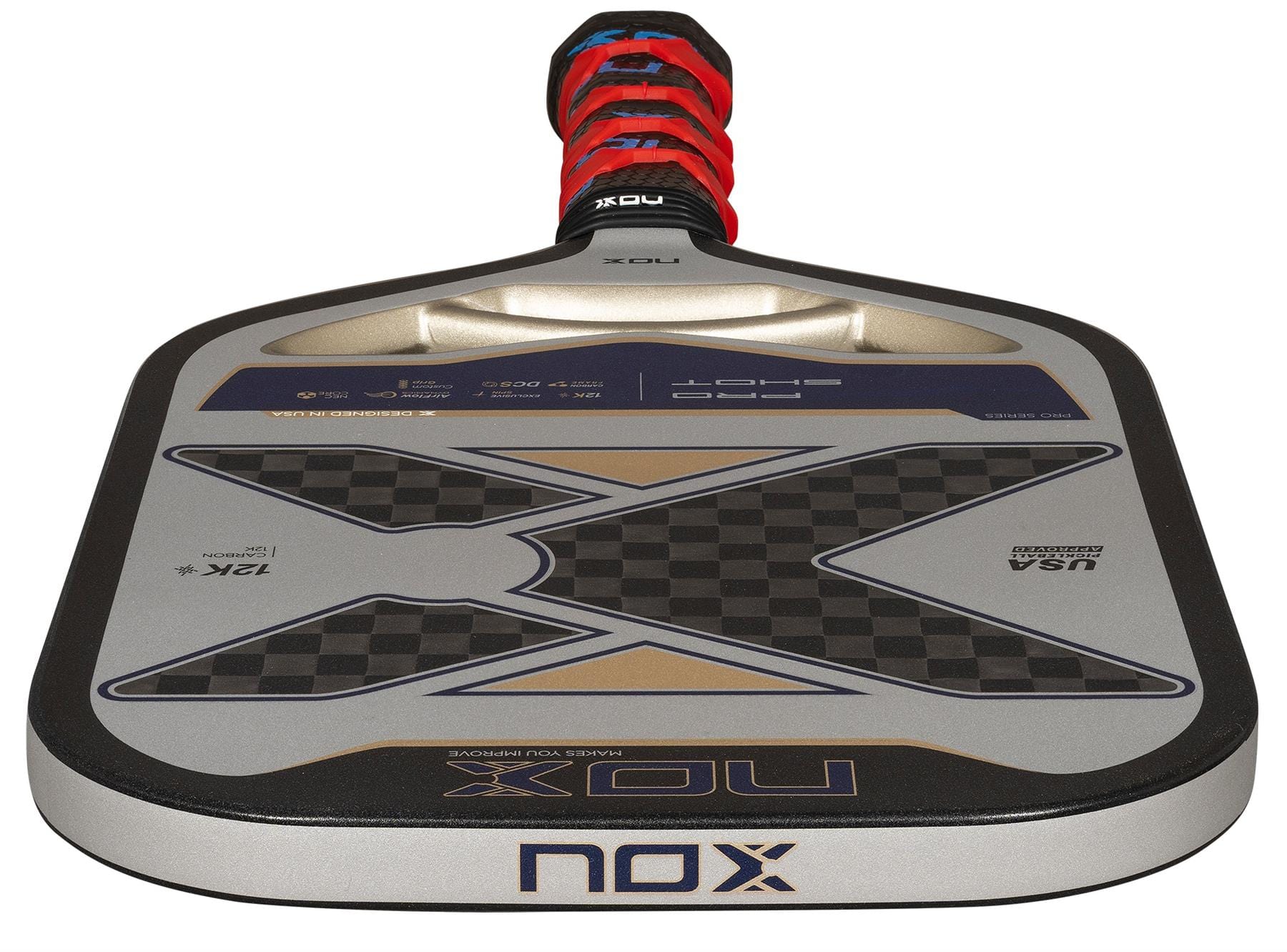A close-up of the NOX Pro Shot Pickleball Paddle features a black, silver, and gray carbon fibre design, a red and black wrapped handle, and a prominent "X" logo on the paddle face.