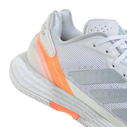 A close-up of the adidas Defiant Speed 2 Womens Tennis Shoes in Cloud White, Halo Blue, and Beam Orange, showcasing a lightweight mesh upper with “DEFIANT SPEED” printed on the heel for top tennis performance.
