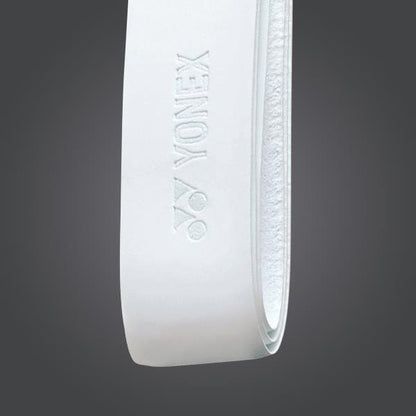 A close-up of a white Yonex AC126EX Replacement Synthetic Leather Grip against a dark background. The logo and brand "Yonex" are embossed on the synthetic leather material, which features a textured surface for improved handling.