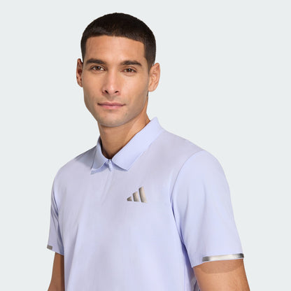 A man in an adidas Climacool Mens Tennis Polo Shirt in Violet Tone stands against a plain light background, facing the camera with a neutral expression.