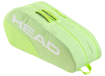 A lime green HEAD BASE 6 Racket Tennis Bag M - SG with "HEAD" in white on its side. It includes two main compartments with visible zippers and two short top carry handles.