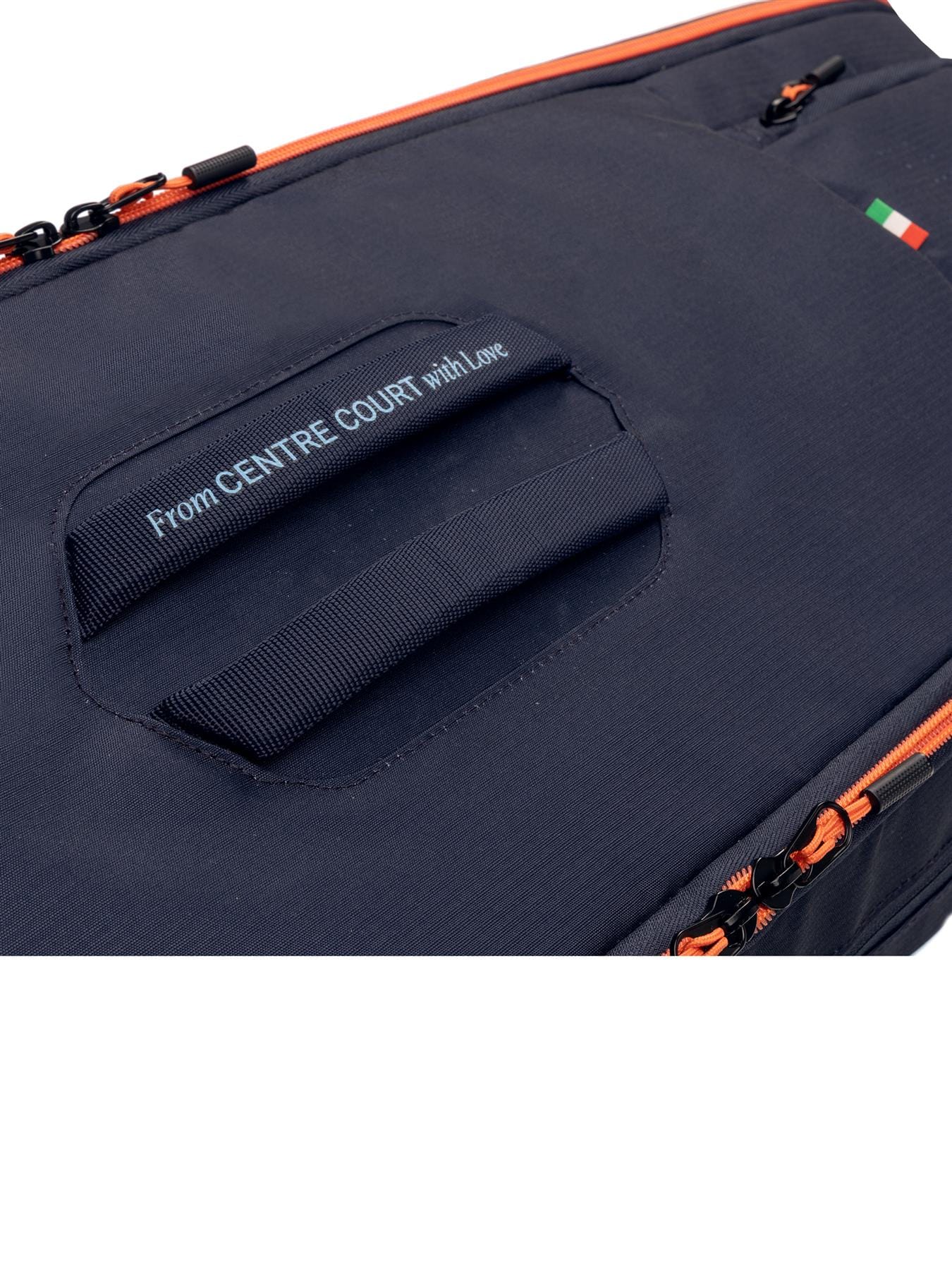 Close-up of the HEAD Pro 9 Racket Tennis Bag L - Navy, featuring orange zippers, a handle, "From CENTRE COURT with Love" text, a small Italian flag, and a tribute to Jannik Sinner for true tennis style.