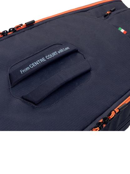 Close-up of the HEAD Pro 9 Racket Tennis Bag L - Navy, featuring orange zippers, a handle, "From CENTRE COURT with Love" text, a small Italian flag, and a tribute to Jannik Sinner for true tennis style.