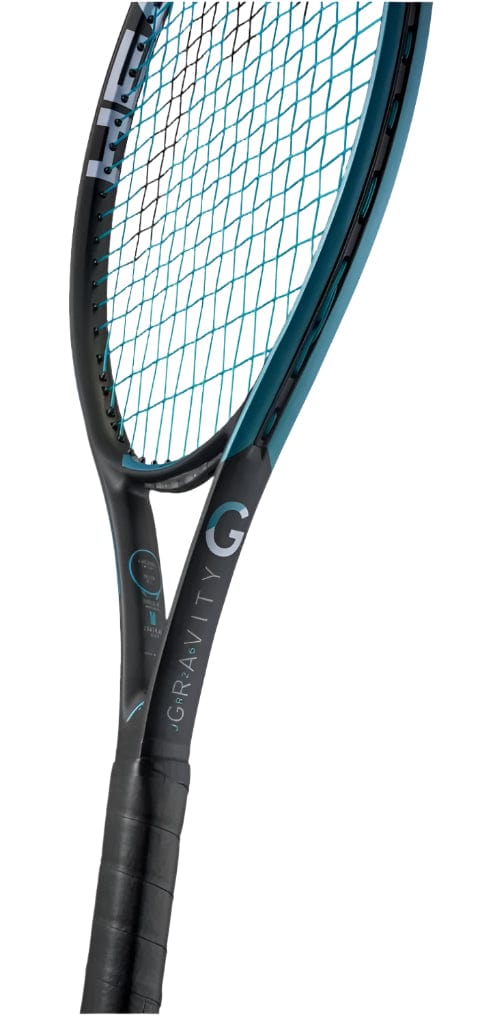 A close-up angled view of a HEAD IG Gravity Junior 26 2025 Tennis Racket by HEAD, featuring a black and teal frame, black grip, blue strings, and “GRAVITY” displayed on the neck of this lightweight graphite racket.