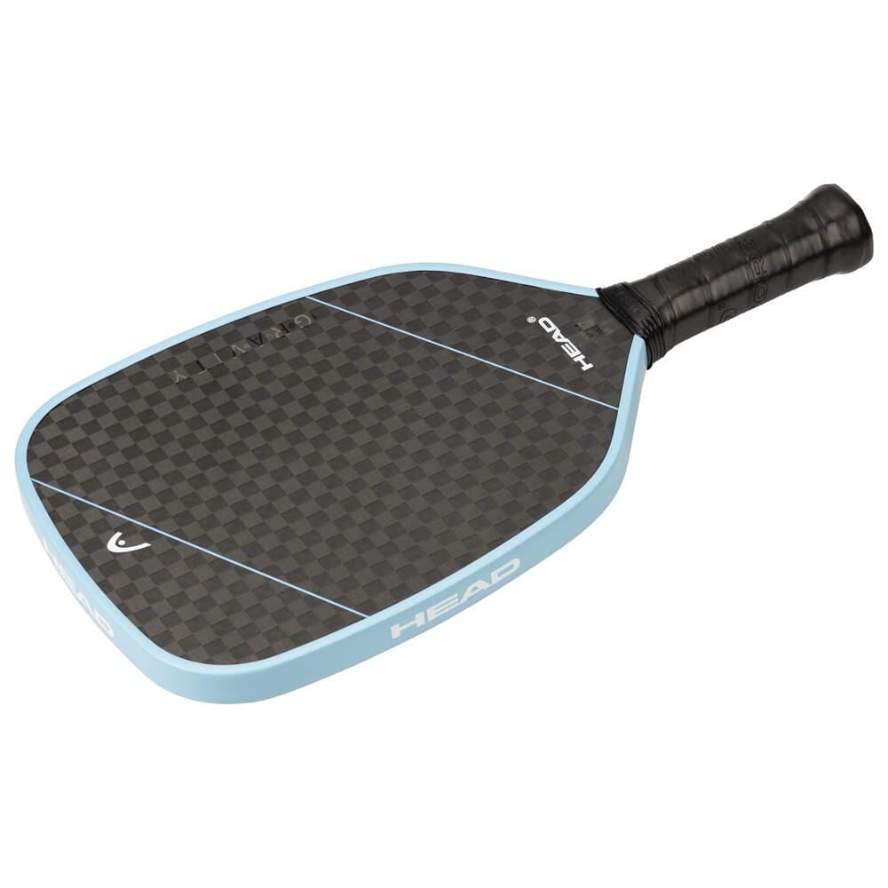 The HEAD Gravity Tour 2025 Pickleball Paddle features a black and gray checkered design, a light blue edge, black grip handle, and "HEAD" branding, with a 12k raw carbon surface for exceptional control and feel.