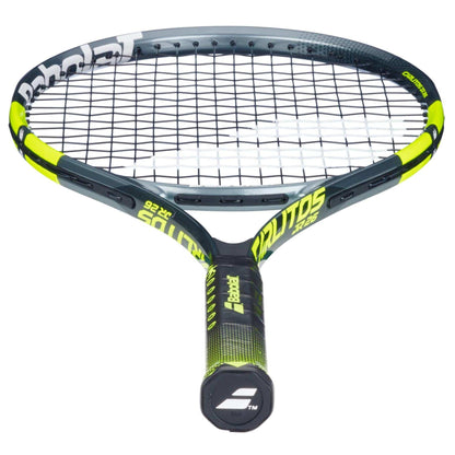 The Babolat Carlitos Junior 26 Tennis Racket features a black and yellow design with white branding, tightly strung strings, and a textured grip—ideal for beginner tennis players.