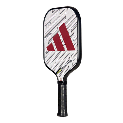 The adidas RX CTRL 3.3 Pickleball Paddle sports a black handle, white face with a red geometric logo, and bold black lines. Its Spin Blade Grit texture boosts control for standout performance on the court.