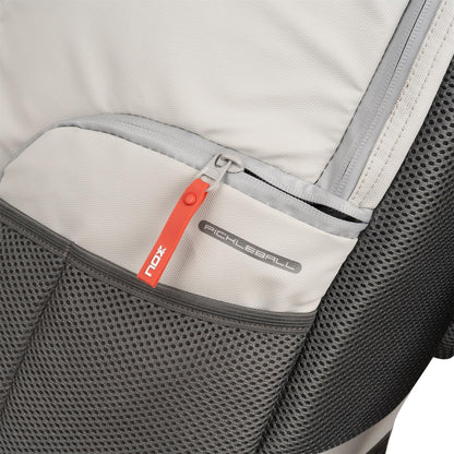 Close-up of the NOX Supra Pickleball Backpack in Cream, showing a red zipper pull with "NOX" branding and a "Pickleball" tag; features include mesh and fabric textures plus ergonomic padded straps for comfort.