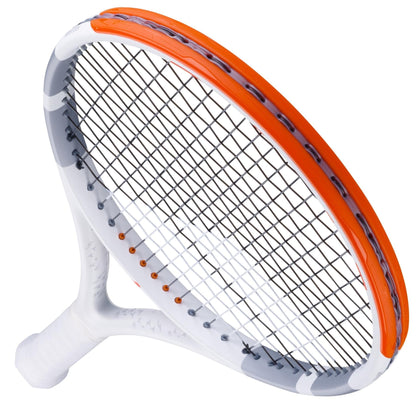 A Babolat Evo Strike Gen 2 tennis racket, branded by Babolat, with a white handle and a red and grey frame, featuring black strings. The image captures an angled perspective that highlights its sleek design and bold color contrast, promising power and control on the court.