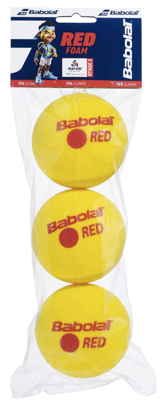 A package of three Babolat Red Foam X3 Tennis Balls for beginners, in clear plastic, labeled "Babolat Red Foam" and "75% slower," featuring a cartoon character; ITF approved.