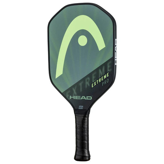 The HEAD Extreme Pro 2023 Pickleball Paddle features a green and black composite surface, bold stylized logo, "EXTREME PRO" text, and a black textured comfort grip handle for superior play.