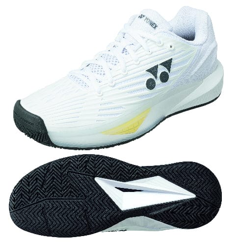 The Yonex Power Cushion Eclipsion 5 Men's Tennis Shoes in white, featuring stylish black accents and a yellow side highlight, showcase both impressive style and functionality. Designed specifically for tennis, these athletic shoes have a sole with a herringbone pattern to ensure optimal traction.