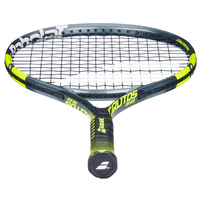 A close-up of the Babolat Carlitos Junior 23 Tennis Racket by Babolat, featuring a black and neon yellow frame, black strings, and textured grip—ideal for young players seeking a quality junior tennis racket.