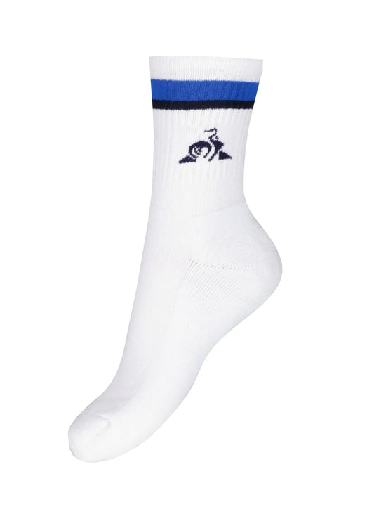 The Le Coq Sportif Sports Socks - Lapis Blue are white and feature a blue and black stripe near the top, complete with a rooster logo above a triangle. Specifically designed for tennis comfort, these socks provide breathability to ensure your feet remain cool and dry on the court.