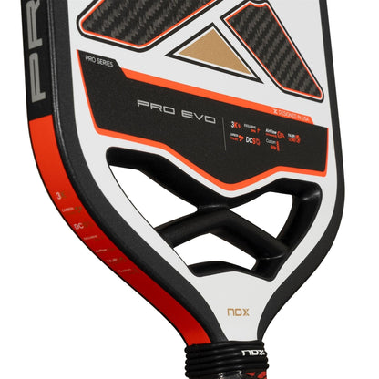 Close-up of the NOX Pro Evo Pickleball Paddle by NOX, featuring a black, white, and red carbon fiber design—ideal for players seeking spin. "PRO SERIES" and "3K Carbon" are clearly highlighted on the paddle.