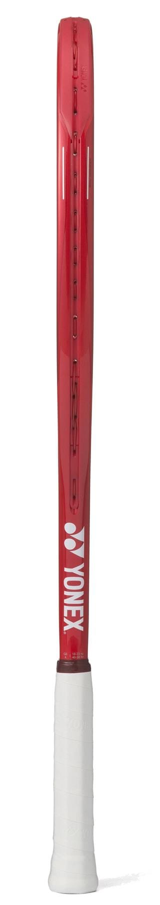 The Yonex VCORE 26 Junior Ruby Red 2026 Tennis Racket, seen from the side, shows "WONDER" in white on the frame edge and a white grip, designed with isometric technology for enhanced play.