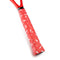 A close-up of the Get A Grip Charged Up Tennis Overgrip in red, displaying its premium quality and unique design adorned with small white lightning bolts, is wrapped around a racket handle. Positioned diagonally, the handle showcases the tennis overgrip's distinctive texture and pattern.