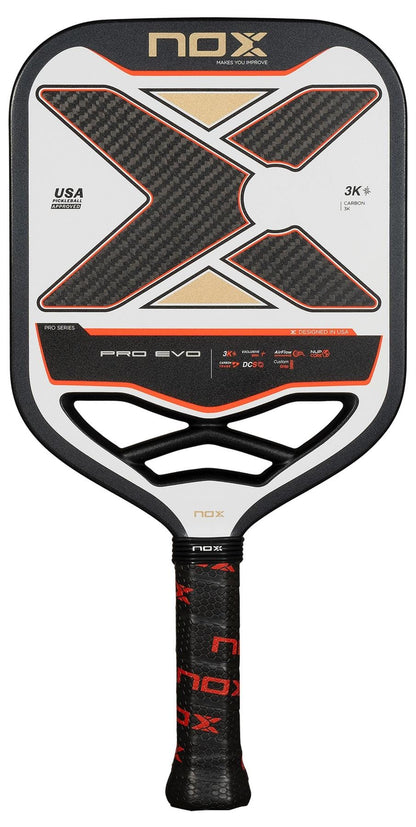 The NOX Pro Evo Pickleball Paddle by NOX boasts a striking black, white, and red look with a large “X” design and textured grip. Its carbon fiber build provides serious players with superior control and spin on the court.