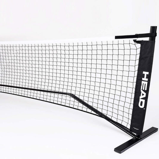 The HEAD 10 and Under Mini Tennis Net - 6.1m is a portable black and white tennis net featuring the "HEAD" logo. Designed for indoor use, it boasts a sleek and sturdy frame, making it ideal for Kids Tennis or 10 and Under Tennis practice and recreational play.