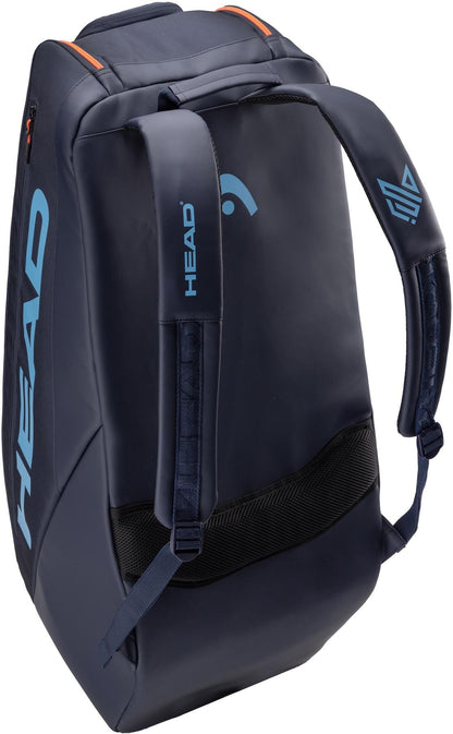 The HEAD Pro 9 Racket Tennis Bag L - Navy features padded shoulder straps, light blue HEAD branding, and orange accents—drawing inspiration from classic tennis bags—perfect for sports or travel.