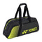 The Yonex 82431WEX Active Tournament Tennis Bag in black/lime, by Yonex, features two handles, the logo, and a striped side design. It includes multiple compartments and a shoe compartment with visible zippers for easy access.