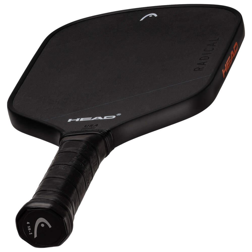 The HEAD Radical Nite Pickleball Paddle features a black textured face, wrapped grip, and "HEAD" branding in white on the face and orange on the side. SpinFusion technology boosts spin, and "RADICAL" is also visible on the paddle.