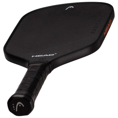 The HEAD Radical Nite Pickleball Paddle features a black textured face, wrapped grip, and "HEAD" branding in white on the face and orange on the side. SpinFusion technology boosts spin, and "RADICAL" is also visible on the paddle.